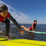 London gets waves. Hawaiian highschoolers get championships. Young New Yorkers get the gift of surf. Surfing vet gets a new tooth.